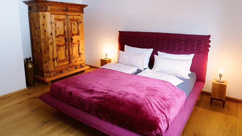 An image of a bedroom with a vintage dresser