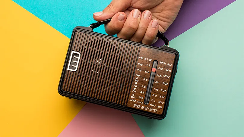 Immagine di una persona che tiene in mano una radio.