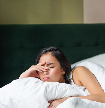 An image of a woman resting in bed